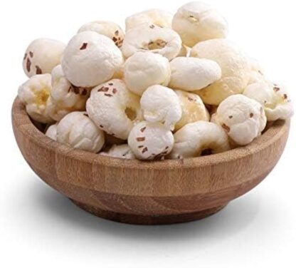 "Close-up image of dried fox nuts (makhana) in a bowl, showcasing their light, white, puffed texture. The nuts are arranged neatly, highlighting their crispy appearance."